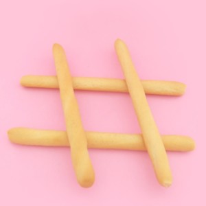 hastag made out of breadsticks on a pink background