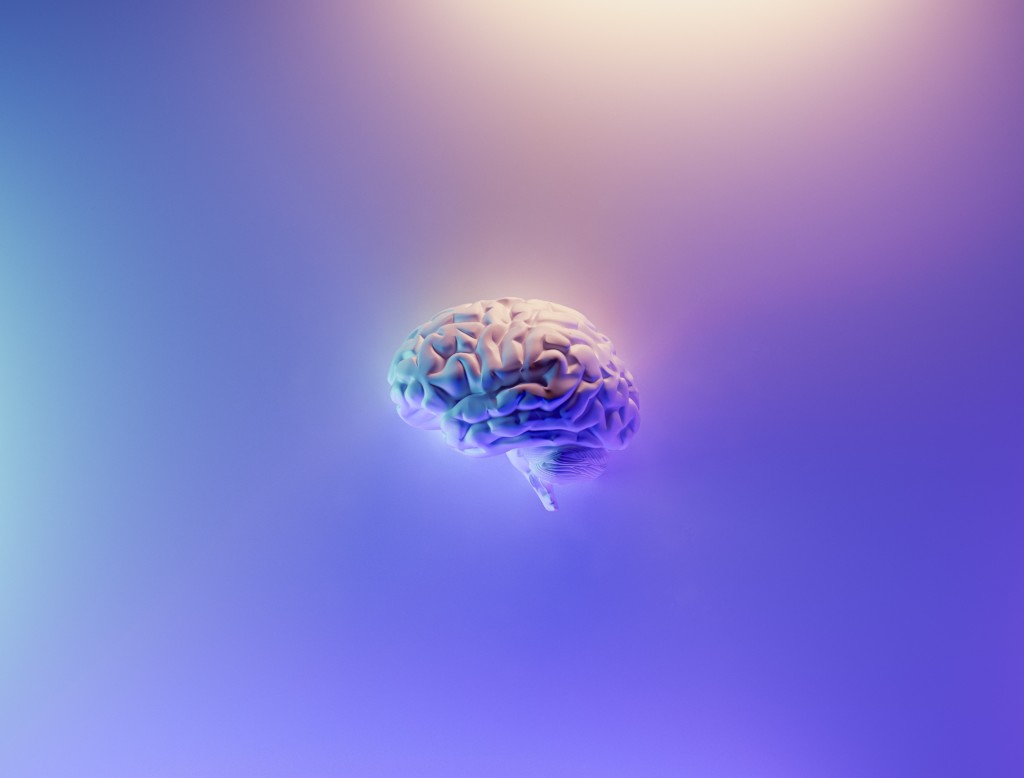 a brain with backlight on purple background