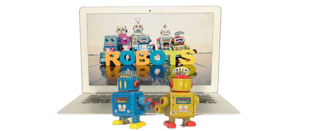 Toy robots looking at a laptop with a screen showing robots