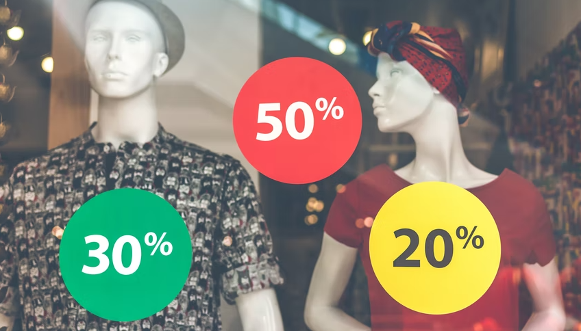 marketing psychology: mannequins in window with discount stickers