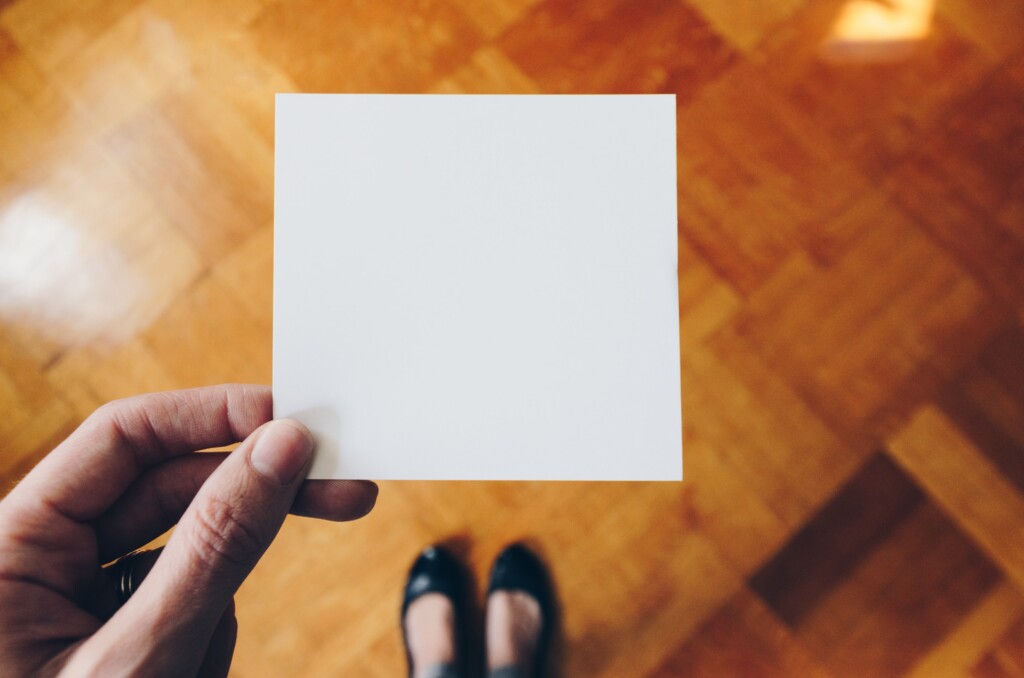 Woman holding a blank piece of paper