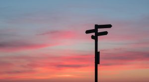 Dusk sky with a signpost 