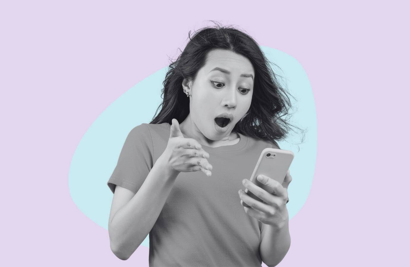 woman looking at phone in shock