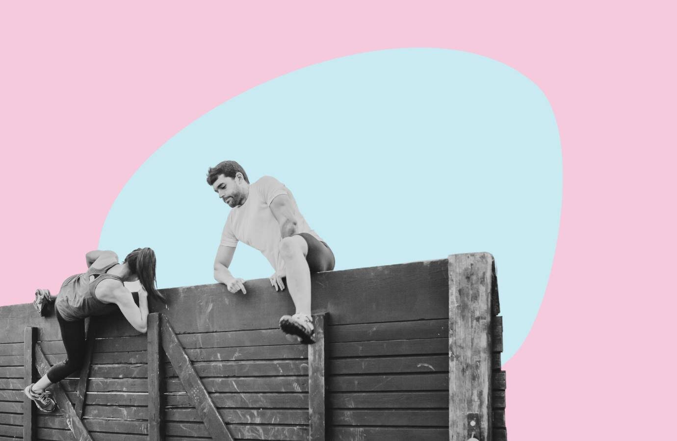 two people scaling a wall