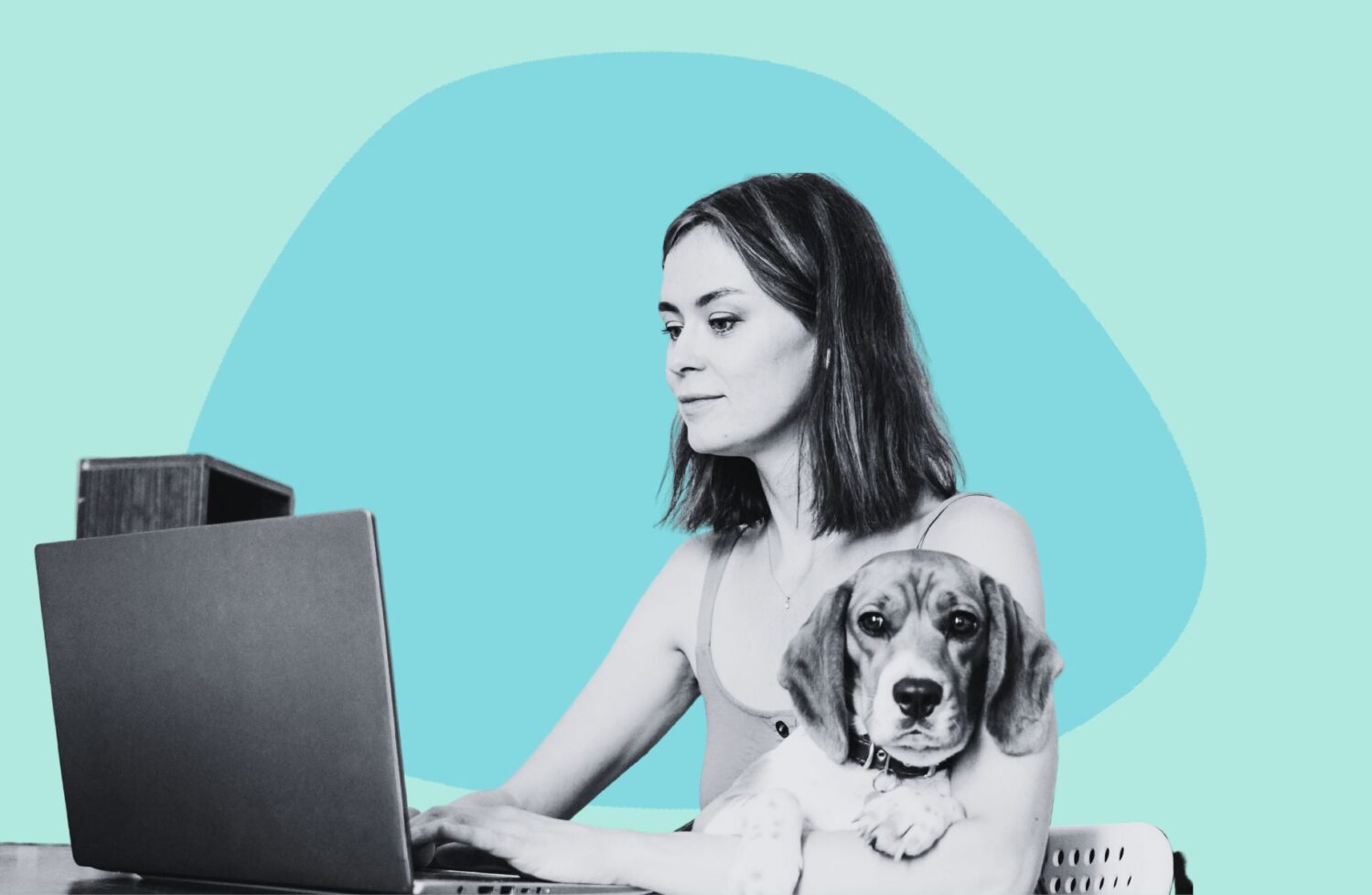 woman working at desk with a dog